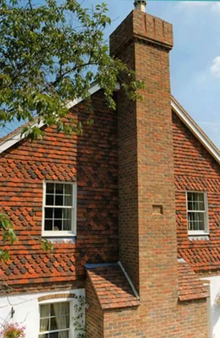 Tile-hung wall in handmade clay tiles