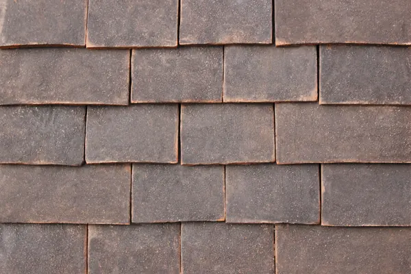 Dark Antique handmade clay tiles laid on a sample panel