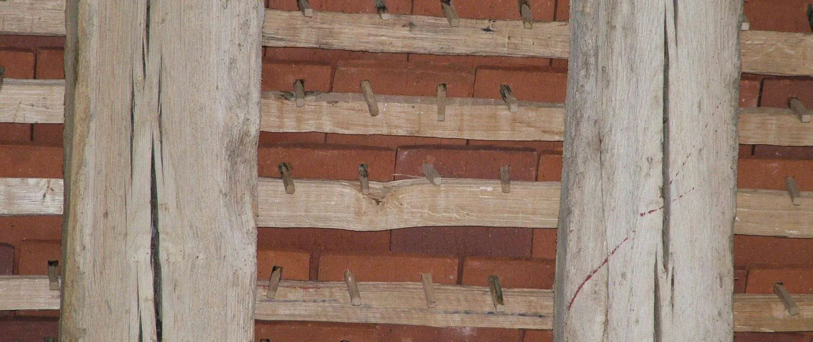 Handmade peg tiles hung on oak battens in an old roof